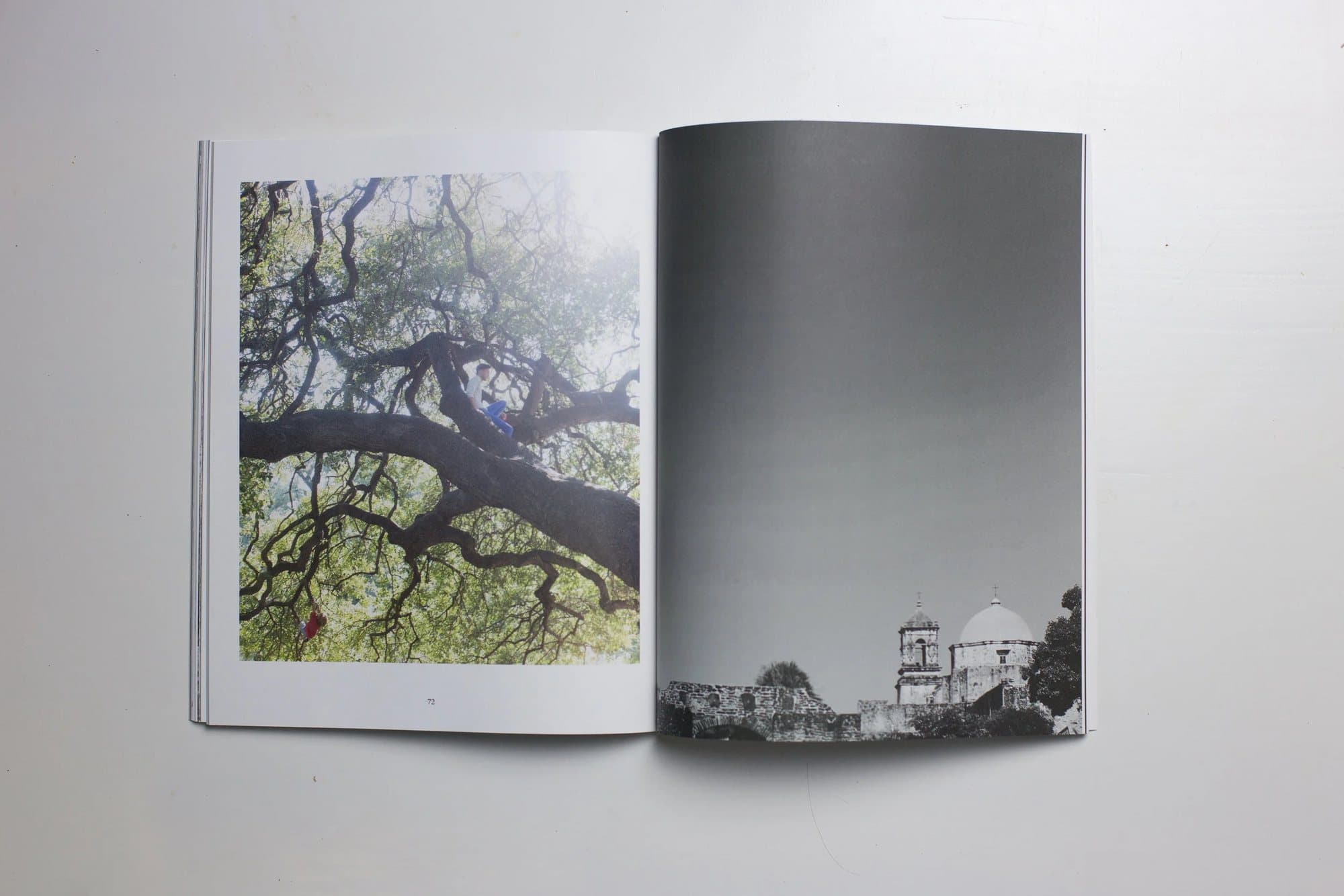 Printed 2015 issue open to a child in a sprawling oak tree and a black and white mission church.