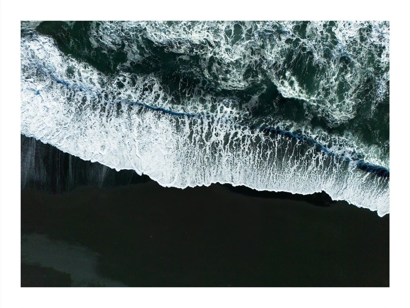 Iceland Black Sands, a TIMELESS archival print of white surf breaking over a black sand beach from above.