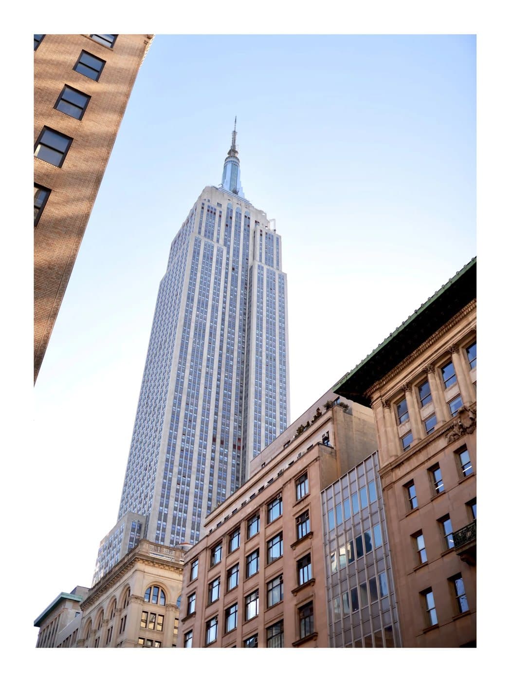 NYC, a TIMELESS archival print looking up at the Empire State Building between Manhattan buildings.