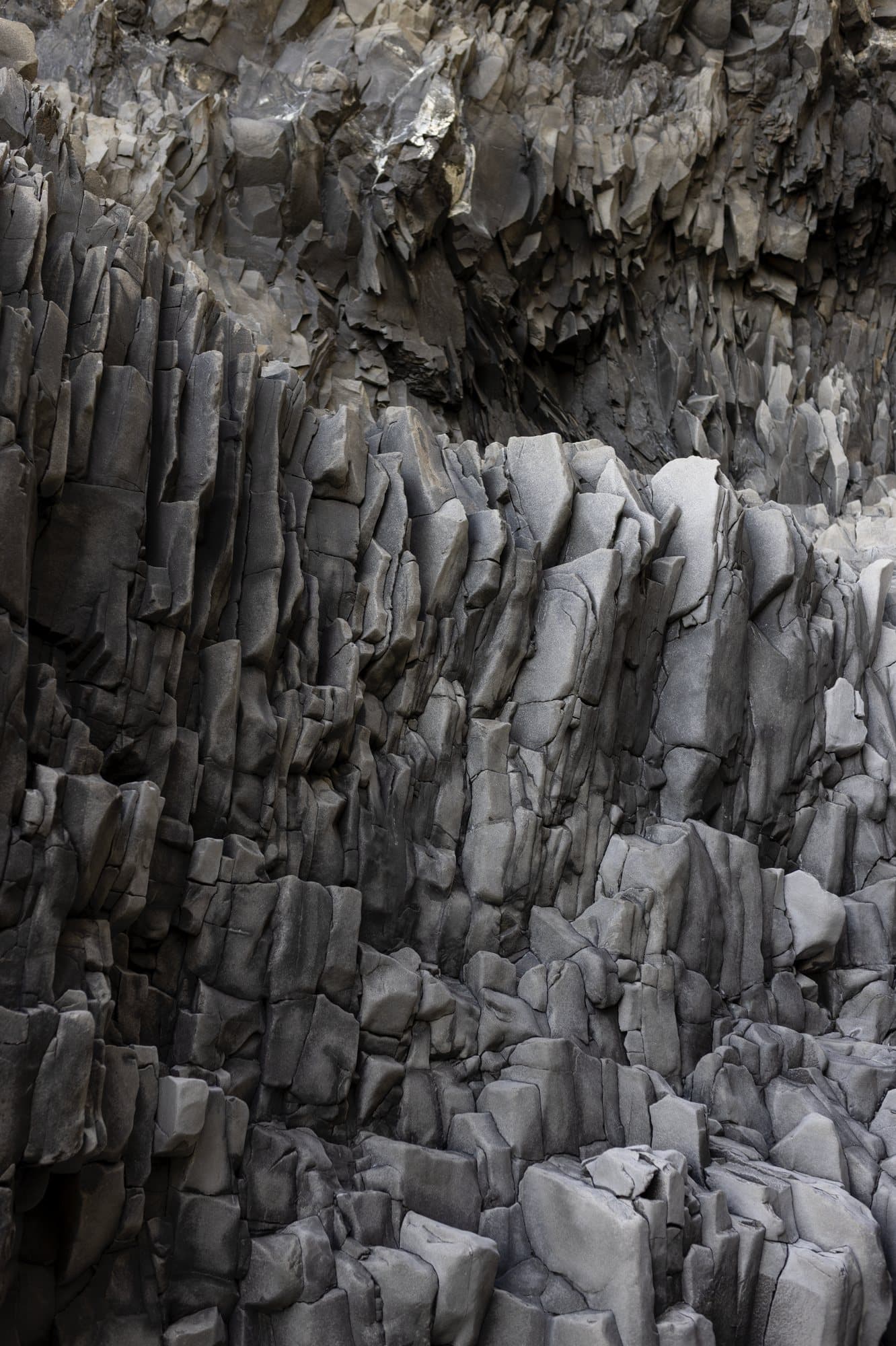 Photo handout of gray basalt columns stacked along an Icelandic cliff.