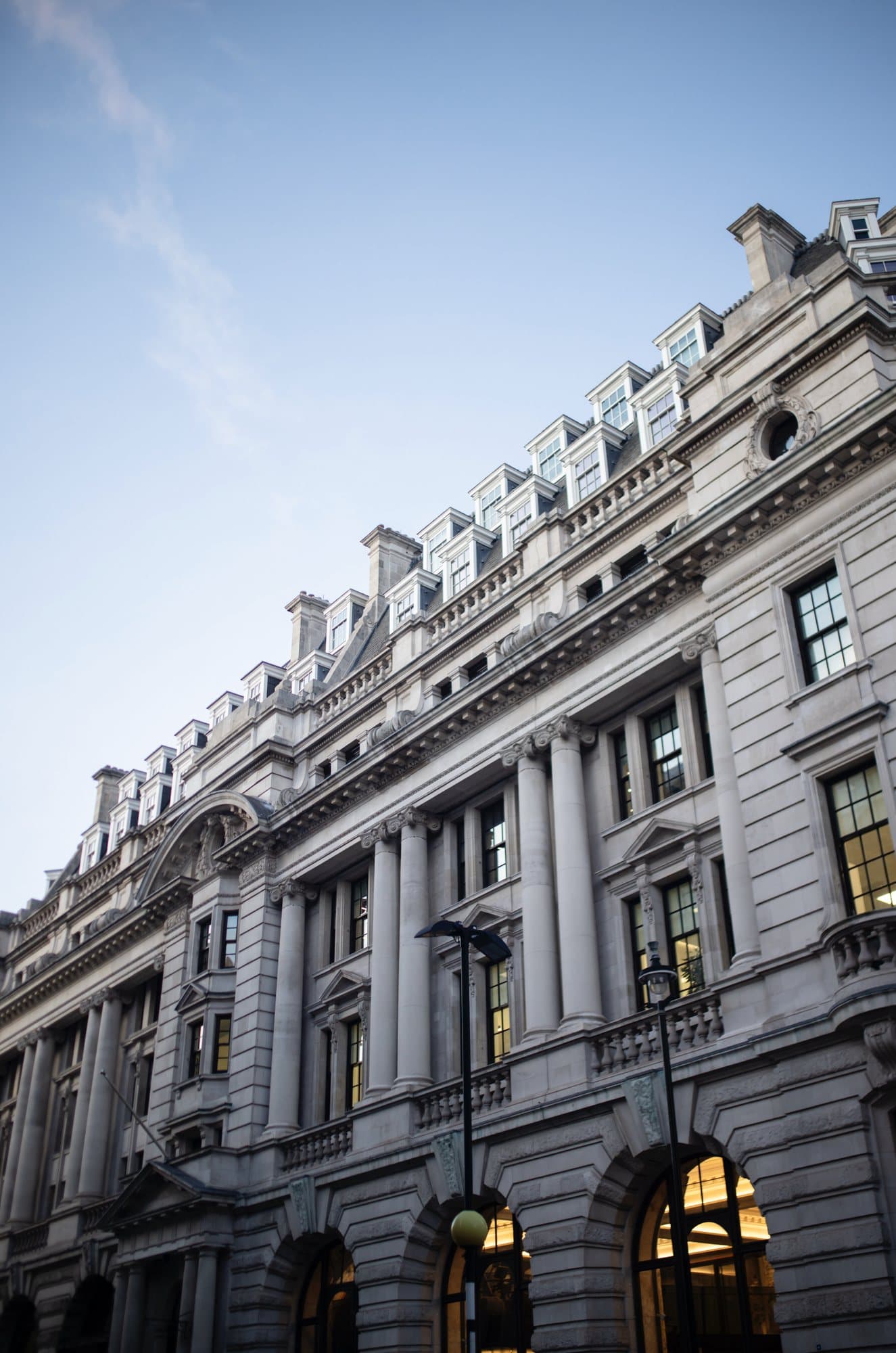 Photo handout looking up at an ornate stone building in London against a blue sky.