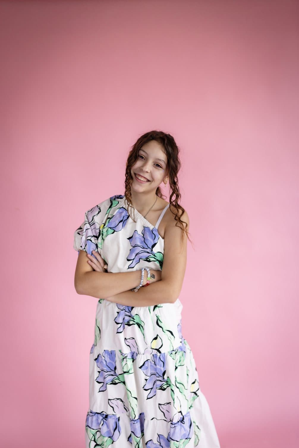 Aila Warnick, featured in Volume 40, smiling in a floral dress against a pink backdrop.