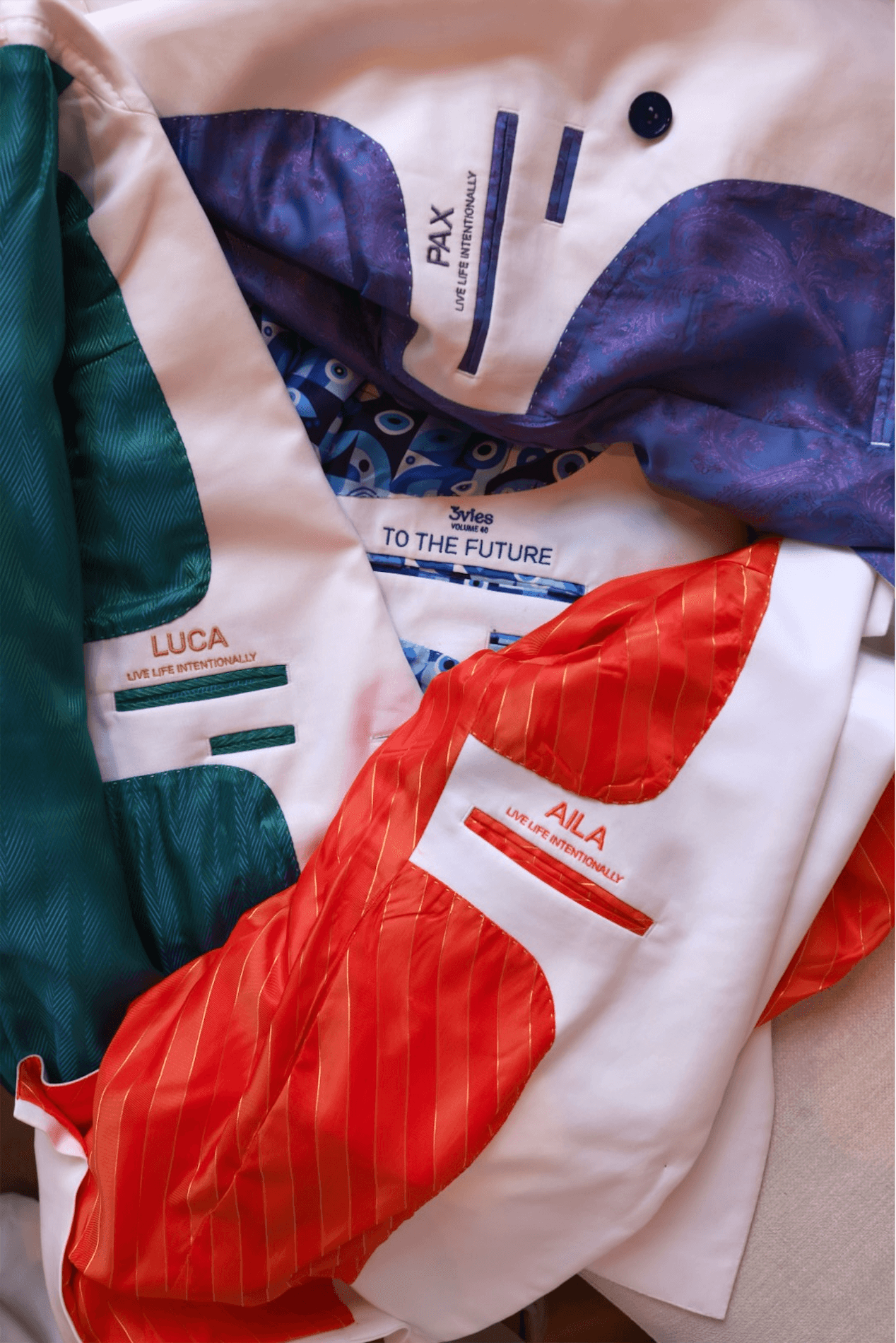 Suit linings embroidered with Pax, Luca, Aila, To the Future, and Live Life Intentionally.