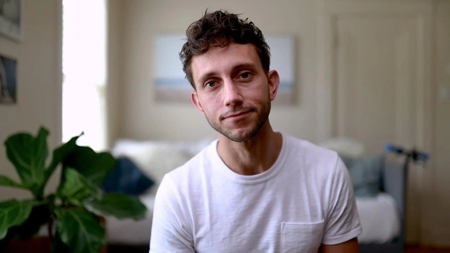 Mark in a white t-shirt at home, a still from his Instagram and YouTube videos.
