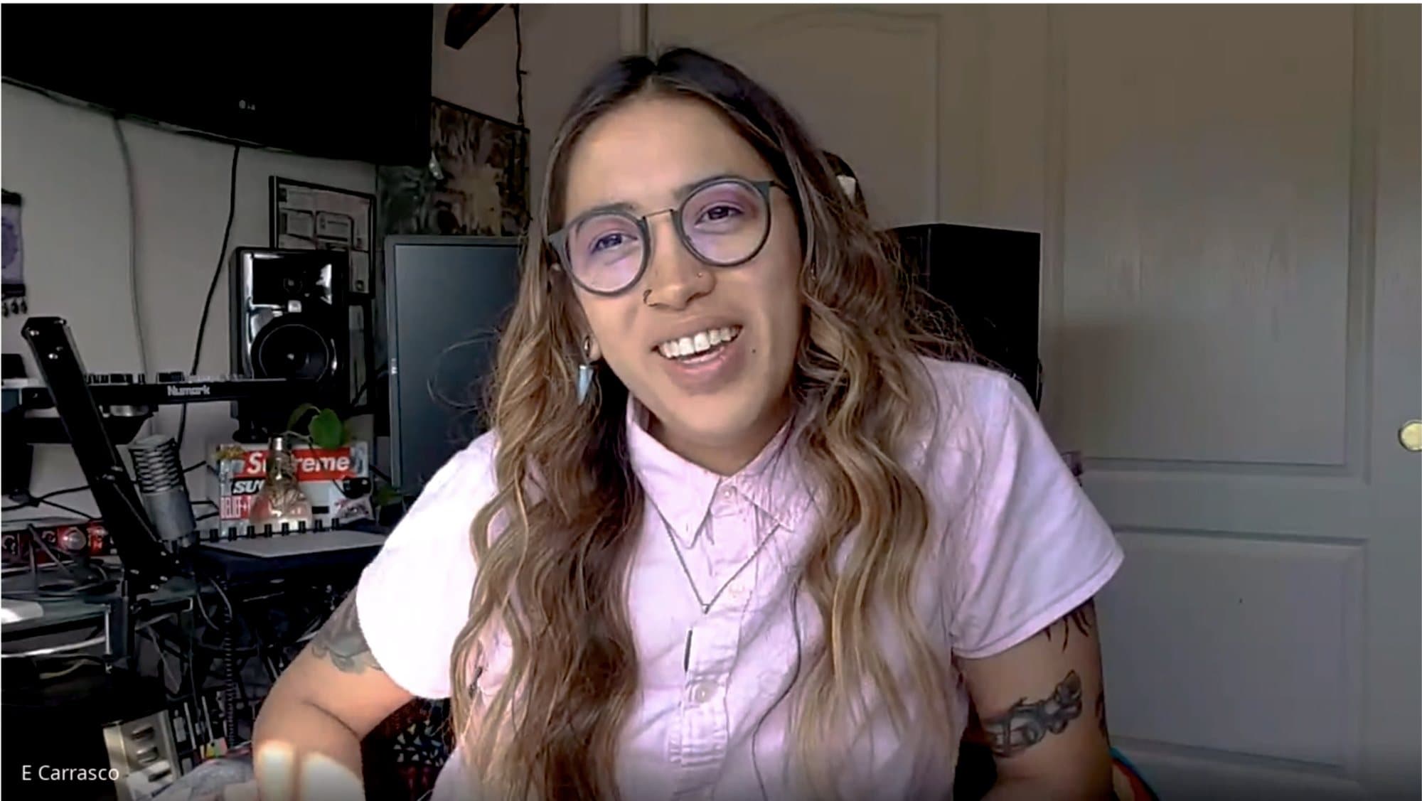 Elena Carrasco smiling on a video call in her home music studio.